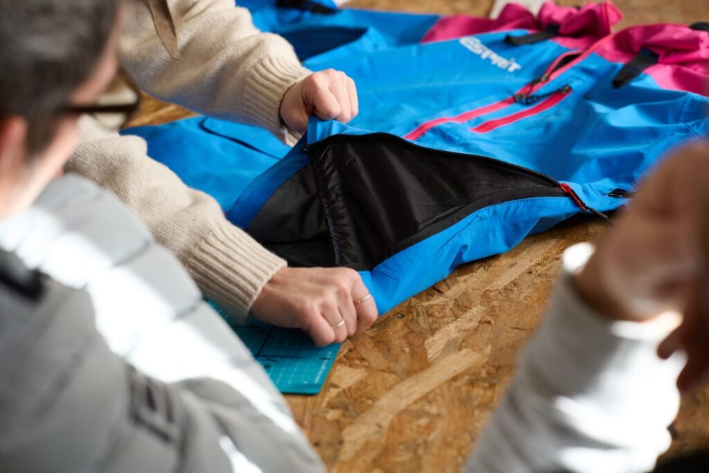 An adaptive ski jacket with added zipped darts in the side to aid fit and comfort for sit skiers