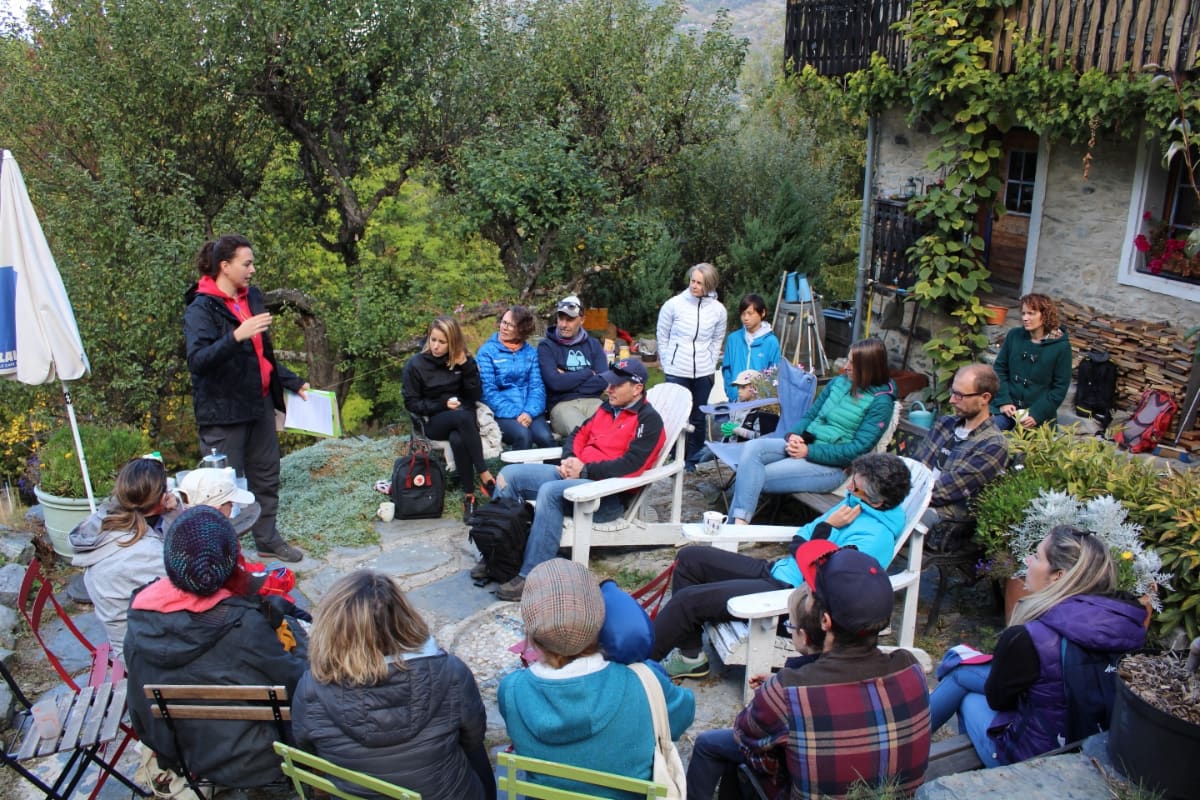 A group of people gathered on a garden terrace for One Tree's official launch