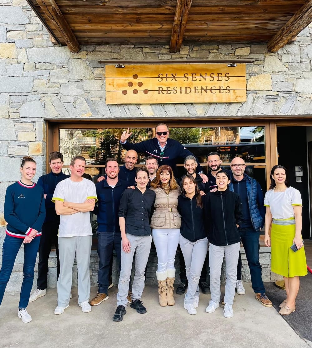 The Six Senses team posing for a photo outside the hotel