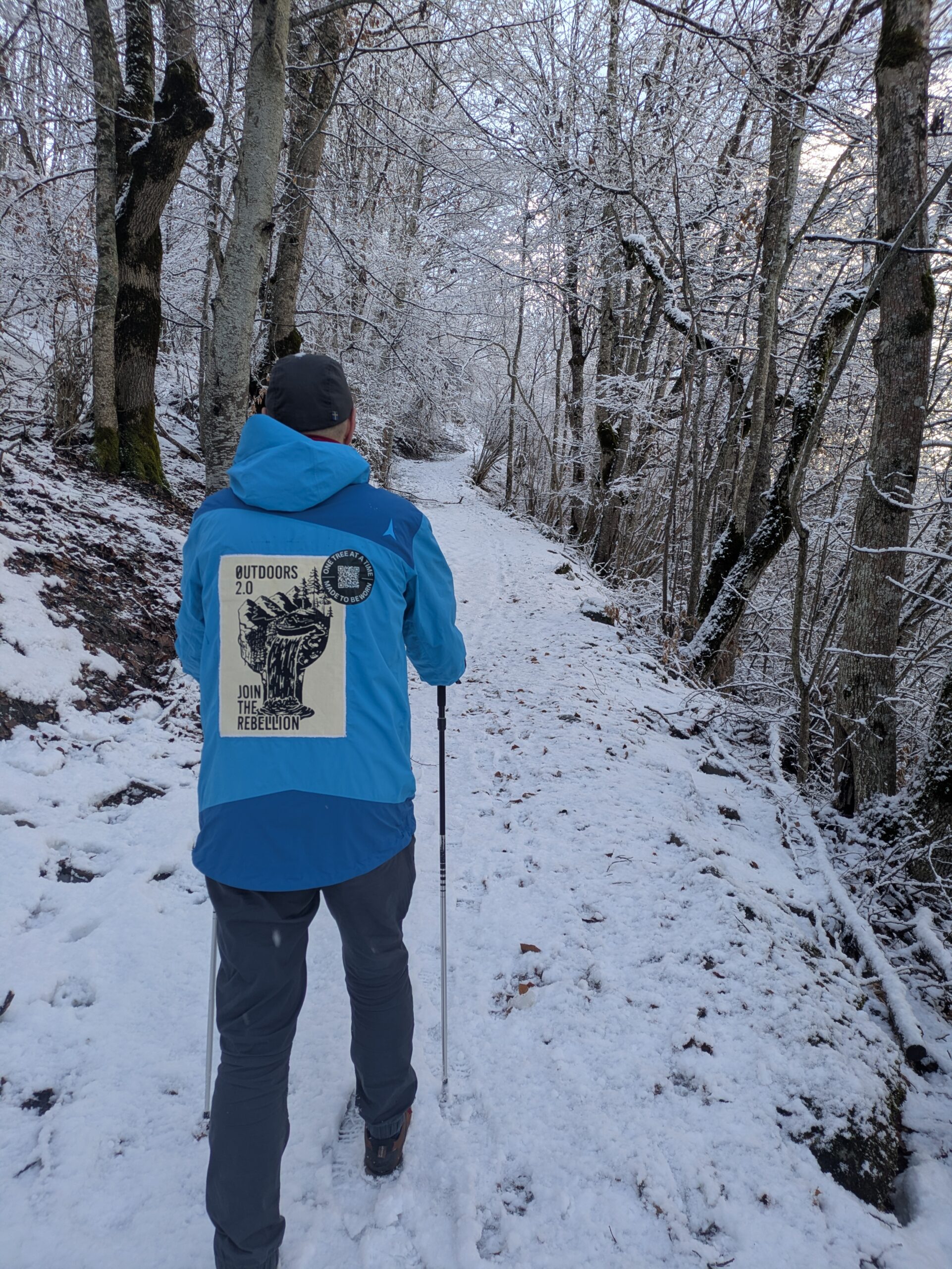 Andy hiking in the snow wearing a Made to be Worn jacket